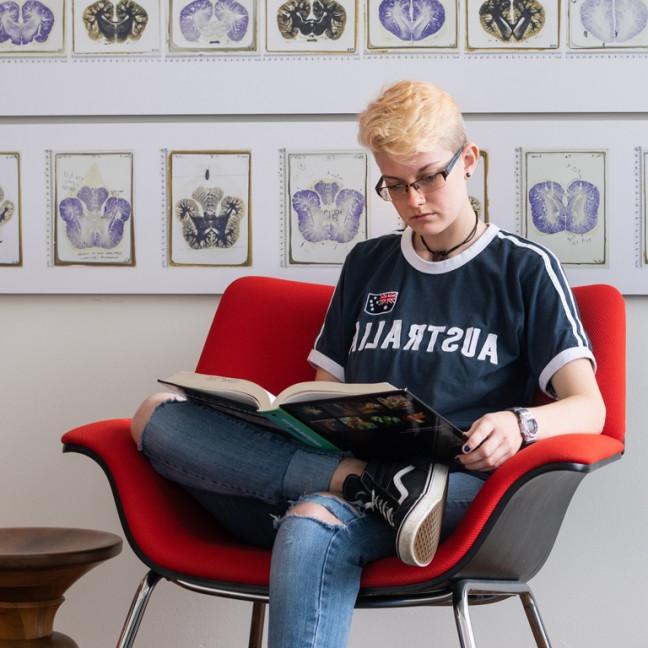 a student studies in an arm chair 
